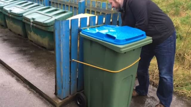 The video suggests using a rubber strap to secure wheelie bins but one islander suggested that would not stop them blowing away.