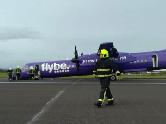 Firefighters at the Flybe aircraft after its emergency landing. Picture: Trish Corbett