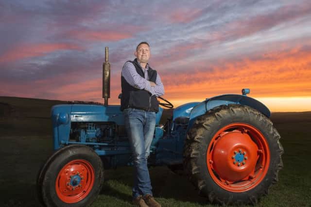 Former Scotland rugby player Doddie Weir with his vintage tractor on his Borders farm. Picture: Ian Rutherford