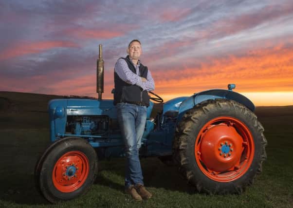 Former Scotland rugby player Doddie Weir with his vintage tractor on his Borders farm. Picture: Ian Rutherford