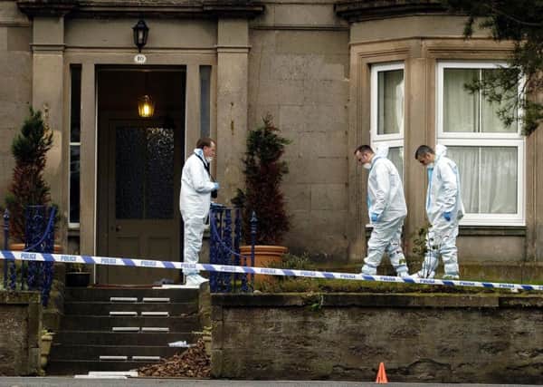 Forensic teams examine the front garden of the home of bank manager Alistair Wilson in Nairn in 2004 after he was gunned down on his doostep. Picture: Andrew Milligan
