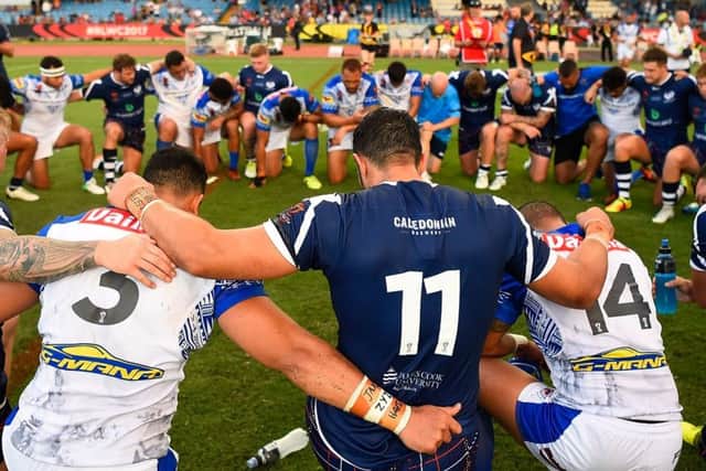 Samoan and Scottish players come together in prayer in Cairns, Australia. Picture: Ian Hitchcock/Getty Images