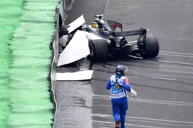 Lewis Hamilton sits in his Mercedes after yesterdays 160mph crash. Photograph: Nelson Almeida/AFP/Getty