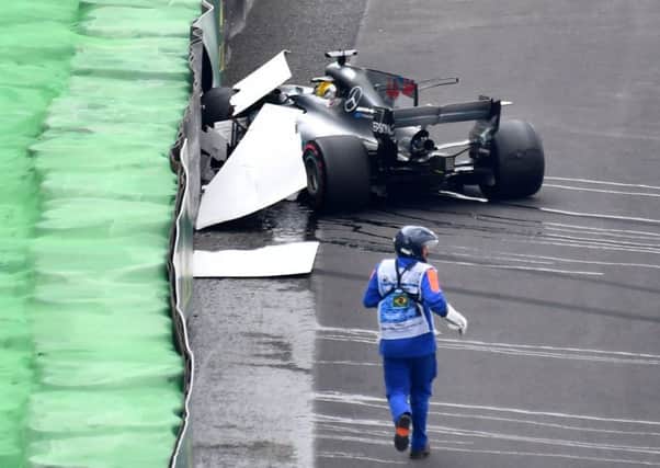 Lewis Hamilton sits in his Mercedes after yesterdays 160mph crash. Photograph: Nelson Almeida/AFP/Getty