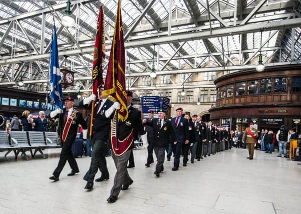 Veterans march at Central Station, Glasgow, yesterday to mark Armistice Day. Photograph: John Devlin