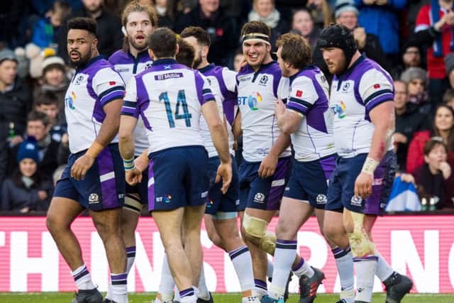 Scotland celebrate after Stuart McInally (centre) scored his try. Picture: SNS/Ross Parker