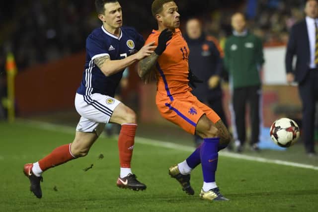 Scotland's Ryan Jack (left) was booed by some home while playing for Scotland against the Netherlands at Pittodrie. Picture: Craig Williamson/SNS