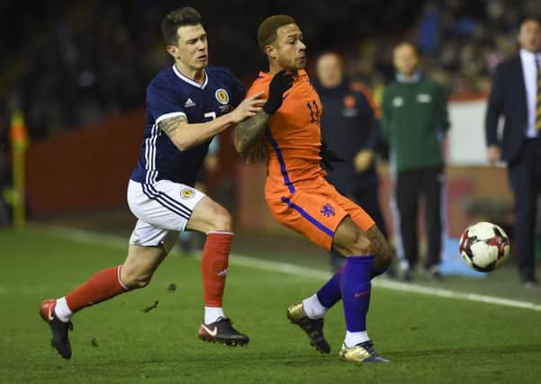 Scotland's Ryan Jack (left) was booed by some home while playing for Scotland against the Netherlands at Pittodrie. Picture: Craig Williamson/SNS