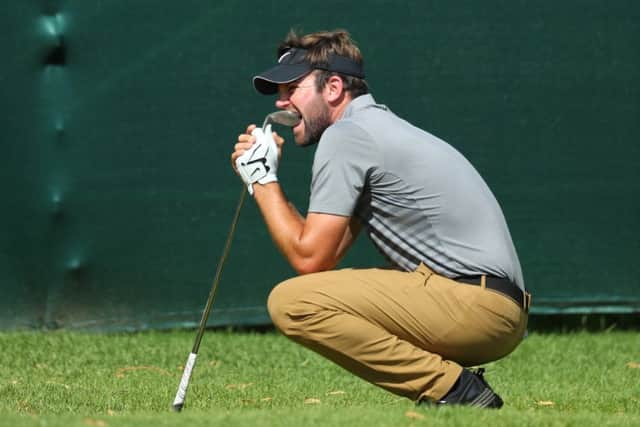 Scott Jamieson bites his wedge in frustration after seeing his chip lip out at the 16th at Sun City. Picture: Getty Images