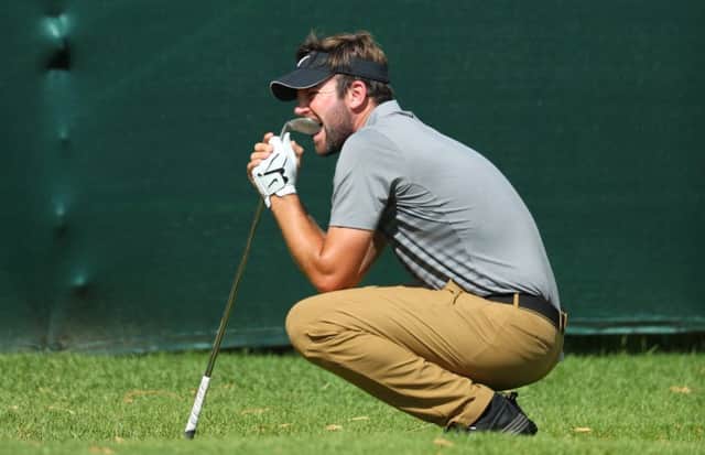 Scott Jamieson bites his wedge in frustration after seeing his chip lip out at the 16th at Sun City. Picture: Getty Images