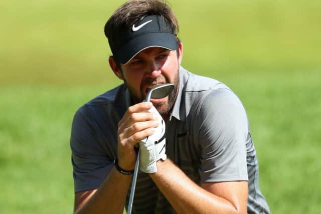 Scott Jamieson bites his wedge in frustration after seeing his chip lip out at the par-3 16th hole. Picture: Warren Little/Getty