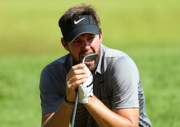 Scott Jamieson bites his wedge in frustration after seeing his chip lip out at the par-3 16th hole. Picture: Warren Little/Getty