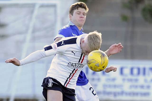 Dom Thomas (back) on loan at Queen of the South last season. Picture: Michael Gillen