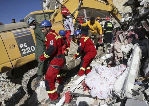 Rescuers are digging through the debris of buildings felled by the Sunday earthquake that killed more than four hundreds of people in the border region of Iran and Iraq. Picture: AP Photo/Vahid Salemi