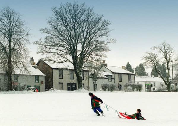Children playing in the snow at Eaglesham. The village in East Renfrewshire was the location of Scotland's first conservation area in 1968. Picture: Allan Milligan/TSPL