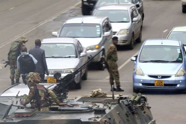 Armed soldiers patrol a street in Harare, Zimbabwe (AP Photo)
