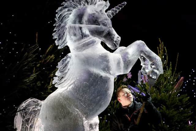 Master ice sculptor Jack Hackney puts the finishing touches to an ice sculpture of a unicorn for Ice Adventure: A Journey Through Frozen Scotland. Picture: Jane Barlow/PA Wire