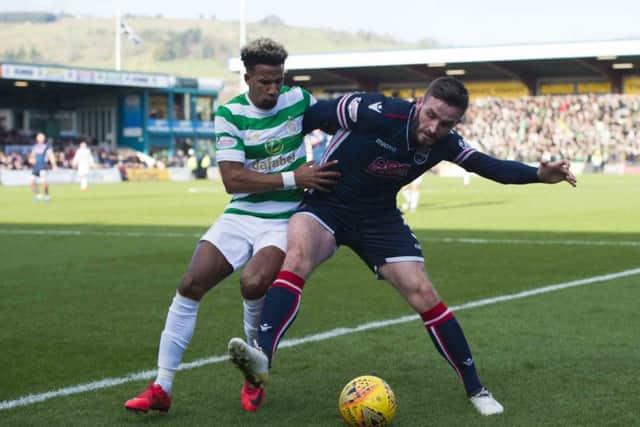 Celtic's Scott Sinclair competes with Ross County's Jason Naismith. Picture: SNS/Ross Parker