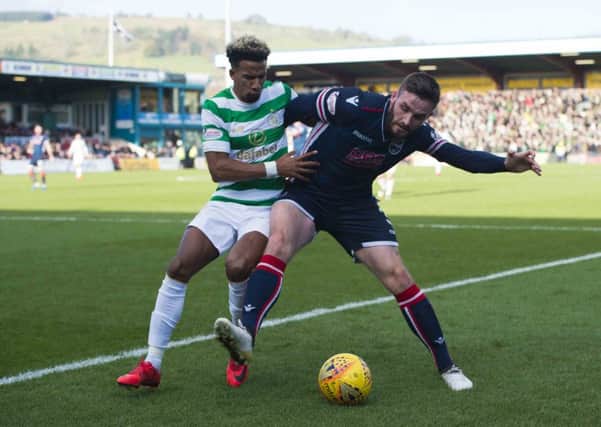 Celtic's Scott Sinclair competes with Ross County's Jason Naismith. Picture: SNS/Ross Parker