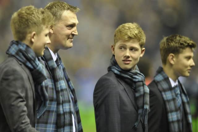 A clearly emotional Doddie Weir, flanked by his three sons, Angus, Hamish and Ben, leaves the pitch having delivered the match ball before Scotland's game with New Zealand. Picture:
Neil Hanna