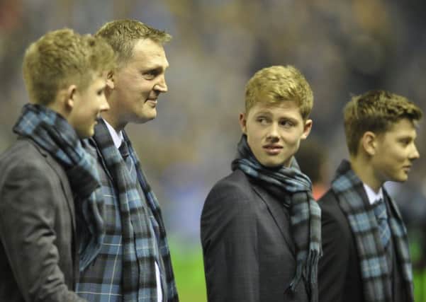 A clearly emotional Doddie Weir, flanked by his three sons, Angus, Hamish and Ben, leaves the pitch having delivered the match ball before Scotland's game with New Zealand. Picture:
Neil Hanna