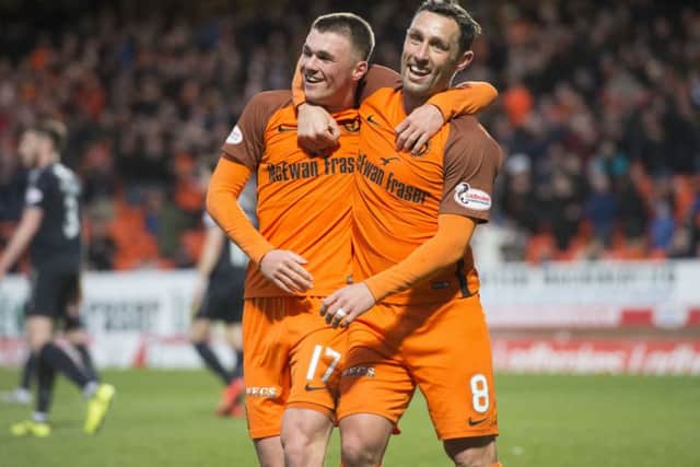 Dundee United's Jamie Robson celebrates his goal with team-mate Scott McDonald. Picture: SNS