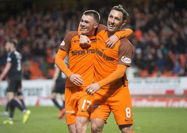 Dundee United's Jamie Robson celebrates his goal with team-mate Scott McDonald. Picture: SNS