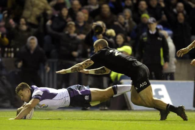 Huw Jones finishes off a magnificent move for Scotlands second try against New Zealand on Saturday. Picture: Neil Hanna.