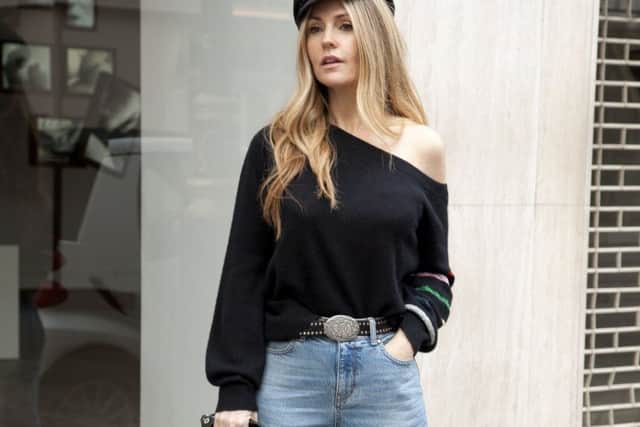 Donna Ida Thornton wears DONNA IDA Studio 54 Off The Shoulder Cashmere Knit, Boy Dazzler Jeans in Throw Back and Midwest Surprise Leather Belt