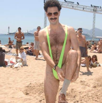 Sacha Baron Cohen, dressed as Borat, has offered to pay the fines of Czech tourists arrested for wearing the fluorescent green mankinis made famous in the film Borat. Picture: Ian West/PA Wire