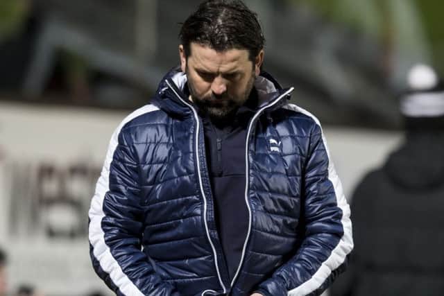 Falkirk manager Paul Hartley cuts a dejected figure after the full-time whistle at Tannadice. Picture: SNS