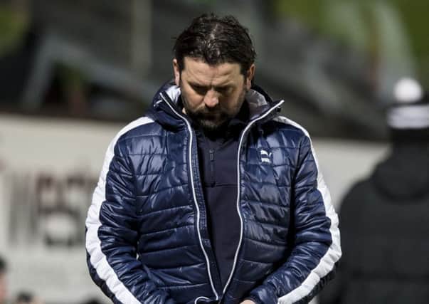 Falkirk manager Paul Hartley cuts a dejected figure after the full-time whistle at Tannadice. Picture: SNS