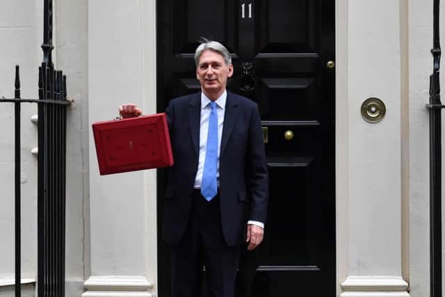 Philip Hammond poses for pictures with the Budget Box. Picture: AFP/Getty