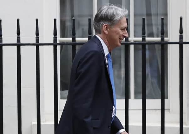 Chancellor Philip Hammond joked about using 'long, economicky words' in his Budget speech (AP Photo/Kirsty Wigglesworth)