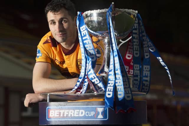 Motherwell's Carl McHugh with the Betfred Cup. Picture: Craig Foy/SNS