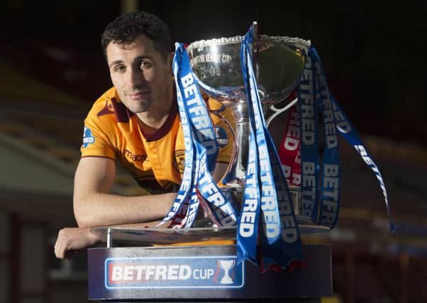 Motherwell's Carl McHugh with the Betfred Cup. Picture: Craig Foy/SNS