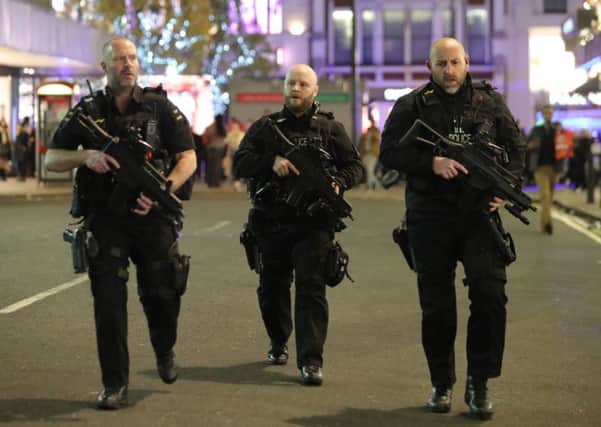Armed police patrol near Oxford street as they respond to an incident in central London. Picture: Daniel LEAL-OLIVASDANIEL LEAL-OLIVAS/AFP/Getty Images
