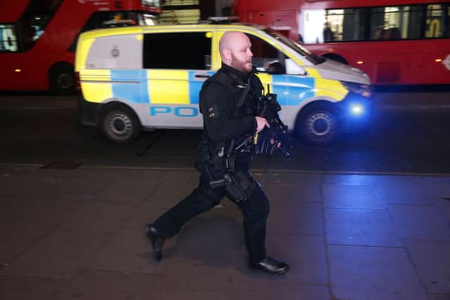 An armed policeman runs down Oxford Street in central London. Picture: Daniel LEAL-OLIVASDANIEL LEAL-OLIVAS/AFP/Getty Images