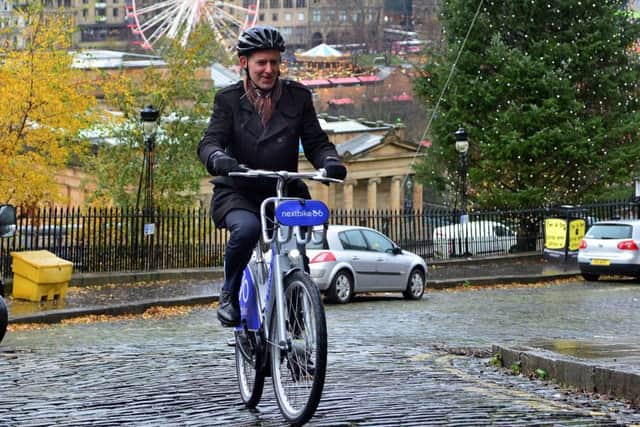 Scotsman transport correspondent Alastair Dalton tries out one of the electric bicycles that will be able for hire in Edinburgh from next year. Picture: Jon Savage