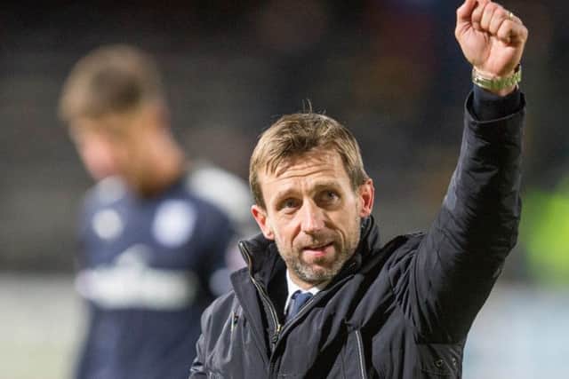 Dundee manager Neil McCann salutes the crowd at the final whistle. Picture: PA