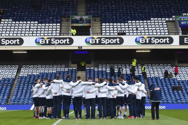 The Scotland players gather on the pitch. Picture: SNS/SRU Gary Hutchison