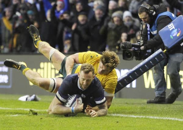 Australia's Michael Hooper can't stop Byron McGuigan touching down one of Scotland's eight tries. Picture: Neil Hanna
