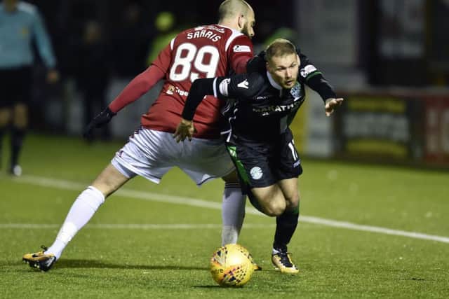 Hibs striker Martin Boyle evades the close attentions of Georgios Sarris during Saturdays game in Hamilton. Picture: SNS.