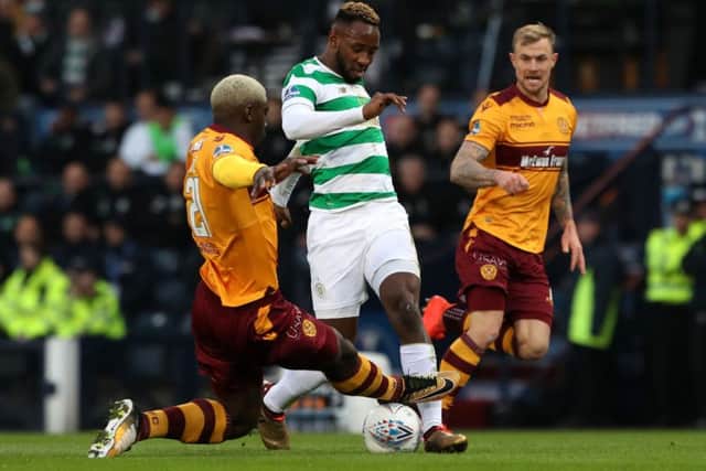 Motherwell's Cedric Kipre goes over the top of the ball after making a challenge on Celtic striker Moussa Dembele. Picture: PA