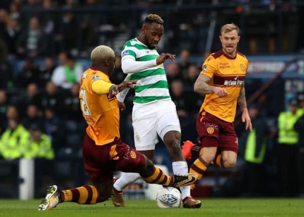 Motherwell's Cedric Kipre goes over the top of the ball after making a challenge on Celtic striker Moussa Dembele. Picture: PA