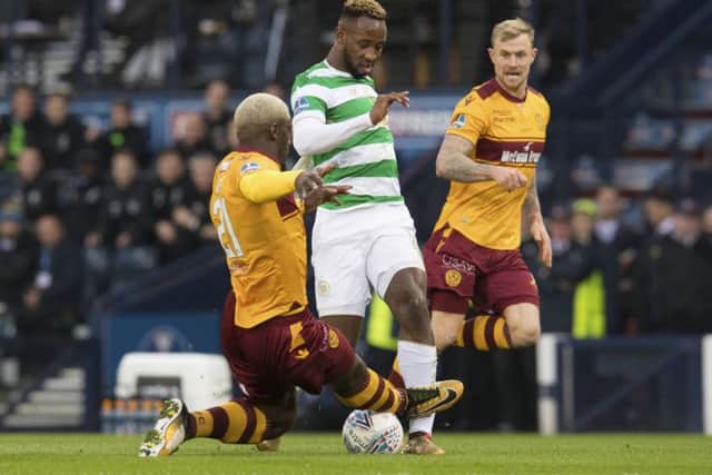 Motherwell's Cedric Kipre (left) challenges Celtic's Moussa Dembele. Picture: SNS