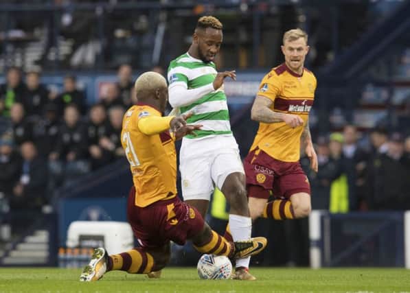 Motherwell's Cedric Kipre (left) challenges Celtic's Moussa Dembele. Picture: SNS