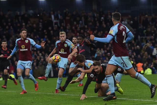 Aaron Ramsay goes down under the challenge of Burnleys James Tarkowski, but no red card was shown. Picture: Getty.
