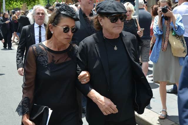 AC/DC lead singer Brian Johnson and his wife Brenda walk in front of AC/DC bassist Cliff Williams as they leave St. Mary's Cathedral. Picture: Getty Images