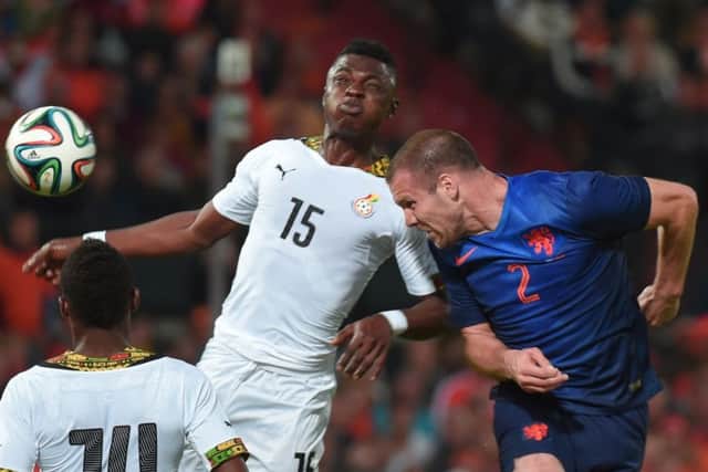 Rashid Sumaila challenges Netherlands defender Ron Vlaar during a friendly match in Rotterdam. Picture: AFP/Getty Images